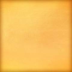 Gold paint on cement wall texture.