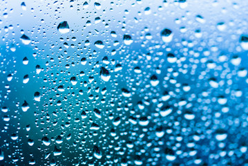 Raindrops on the window, abstract background. Blue tone