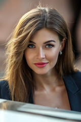 portrait of a beautiful woman against the background of the city. Close-up