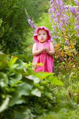 Portrait of cute little girl in summer garden