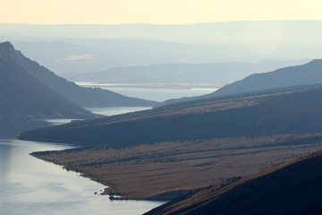Morning mountain layers over a lake
