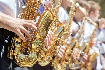 Closeup of a group of saxophonists.
