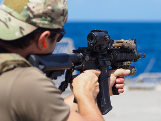 Man shooting rifle,shell ejecting