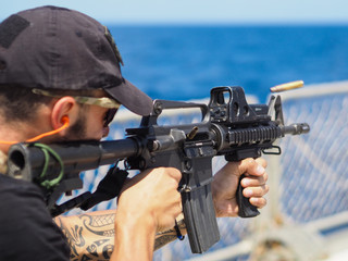 Man shooting rifle,shell ejecting