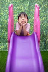 Asian Chinese Little Girl Playing on the slide