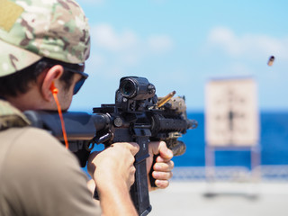 Man shooting rifle,shell ejecting