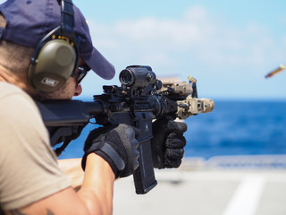 Man shooting rifle,shell ejecting