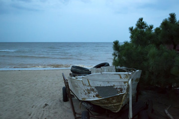 Vintage boat at the coastline against a seascape background.