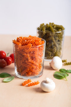 Different types of Italian pasta with vegetables on the table
