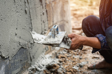 worker are plastering on wall house at construction site