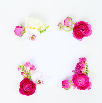 Flowers composition. Frame made of ranunculus and orchidea flowers on white background. Flat lay, top view, copy space