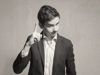 Studio portrait of a teenager boy.Emotions of a person, to attract attention.