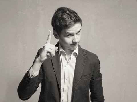 Studio portrait of a teenager boy.Emotions of a person, to attract attention.