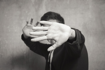 Studio portrait of a teenager boy.Emotions of a person, furtiveness.
