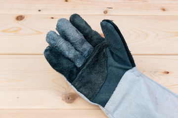 leather work glove on wooden background