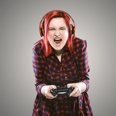 Red haired plus size ordinary woman standing on a neutral grey background. Emotional portrait. She...