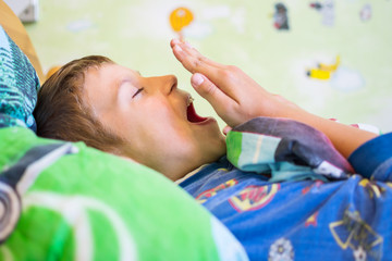 teen boy wakes up in the morning