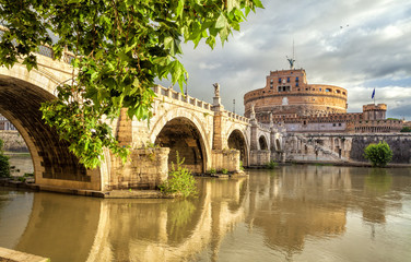 Castle Sant Angelo, bridge Sant Angelo and river Tiber in the rays of sunrise in Roma, Italy. Rome...