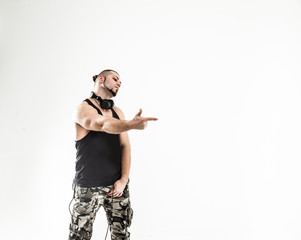 emotional and charismatic DJ - rapper with headphones on a white