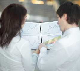 Fototapeta premium rear view.closeup of a business colleagues analyzing financial charts