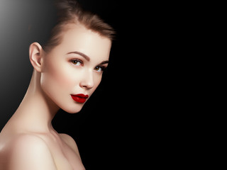 Fototapeta premium Makeup, cosmetics. Beauty young woman portrait. Beautiful model girl with beauty makeup, red lips, perfect fresh skin. Attractive lady with green eyes. Youth and Skin Care Concept
