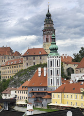 Fototapeta premium Cesky Krumlov castle and ancient historical houses and sky with stormy clouds, Czech Republic..