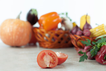 fresh vegetables in wicker baskets on the wooden table.