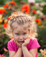 Portrait of cute little girl in summer garden