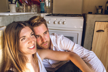 Guy and girl couple smiling and happy in the kitchen. Concept of love and happiness in a couple