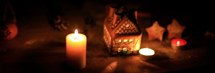 gingerbread house candle on blurred background of the table.
