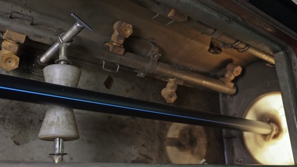 Pipes manufacturing production line. Manufacture of plastic water pipes of the factory. Process of making plastic tubes on the machine tool with the use of water and air pressure.