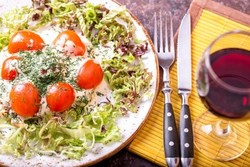  Tasty pork meat  with cherry tomatoes in sauce witj glass of red wine. Fried pork in sauce