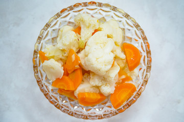 Simple cauliflower and carrot salat with vinegar-oil dressing and onions