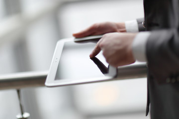 close up.businessman typing on a digital tablet