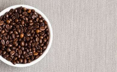 Coffee beans. Bowl of Aromatic Coffee on grey background, close-up. Flat lay