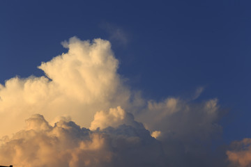 Naklejka na ściany i meble Cumulus at sunset. Sky and clouds background.