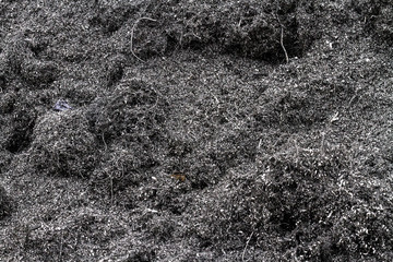 Metal filings lying in an enormous heap in a junkyard
