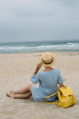 Woman relaxingon the beach in beautiful surroundings