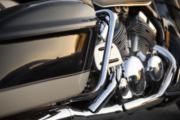Close up view of a shiny chrome motorcycle design engine with exhaust pipes