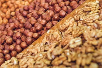 Delicious nuts - hazelnuts and walnuts close-up. Assortment in the market