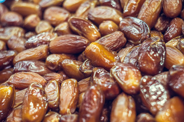 Golden shiny dates close-up. Eastern sweetness. Healthy eating. Assortment in the market