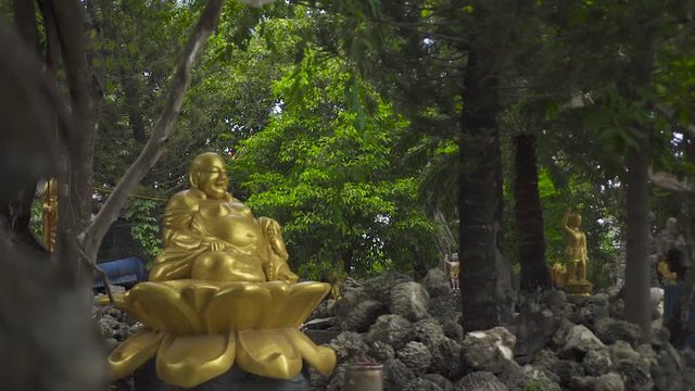 Golden statue god Hotei Budai outdoor. One of seven gods of happiness, communication, fun and prosperity in Japanese mythology