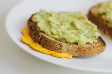Healthy toast with whole grain quinoa bread, avocado and egg. Breakfast meal. Sandwich