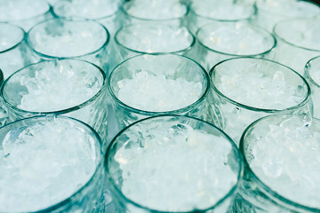 Pattern of glasses with ice ready to prepare a cocktail with refreshing background.