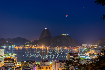 Rio de Janeiro, Brazil - July 27, 2018: The lunar eclipse with the longest 'blood moon' of the century, with the view of Mars, Sugar Loaf Moutain and Guanabara bay also.