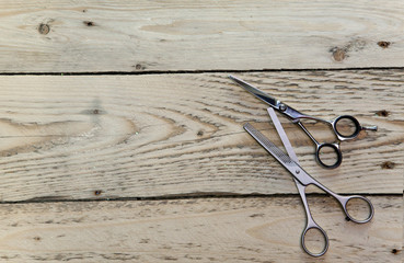 scissors for the hairdresser lie on a wooden board