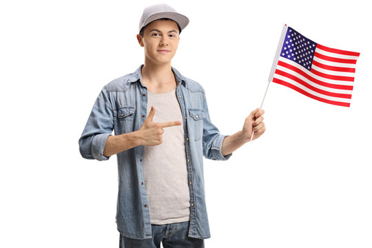 Teenage boy holding an American flag and pointing