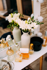 Perfumery and cosmetics on a dressing table with a mirror