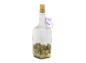 coins into a glass bottle isolated on white background