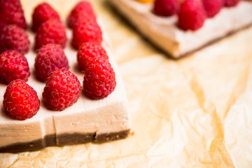 Fresh raspberry cheesecake on the rustic background. Selective focus. Shallow depth of field.